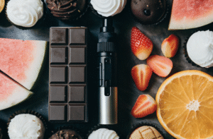 Intense vape flavors for starter kits A collage of colorful fruits and sweets surrounding a sleek starter vape kit.