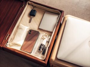 Packing a Disposable Vape for Air Travel A tray at airport security showing a laptop, phone, keys, and a disposable vape in its original packaging.